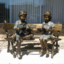 two children sitting on bench reading bronze statue sculpture